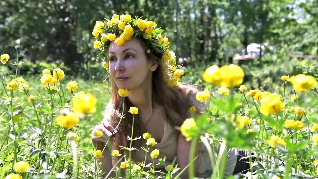 Woman among the flowers of the bathing suit